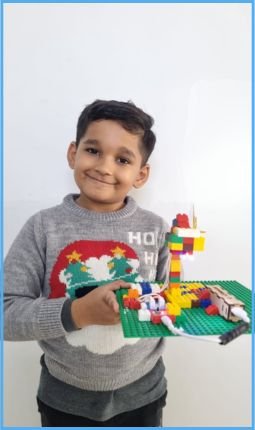 boy with diy night lamp made using lego and havi's kit